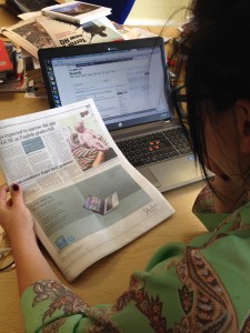 Alex reading The Times, featuring Leah the baby wombat