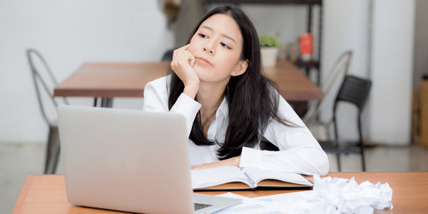 woman thinking at laptop